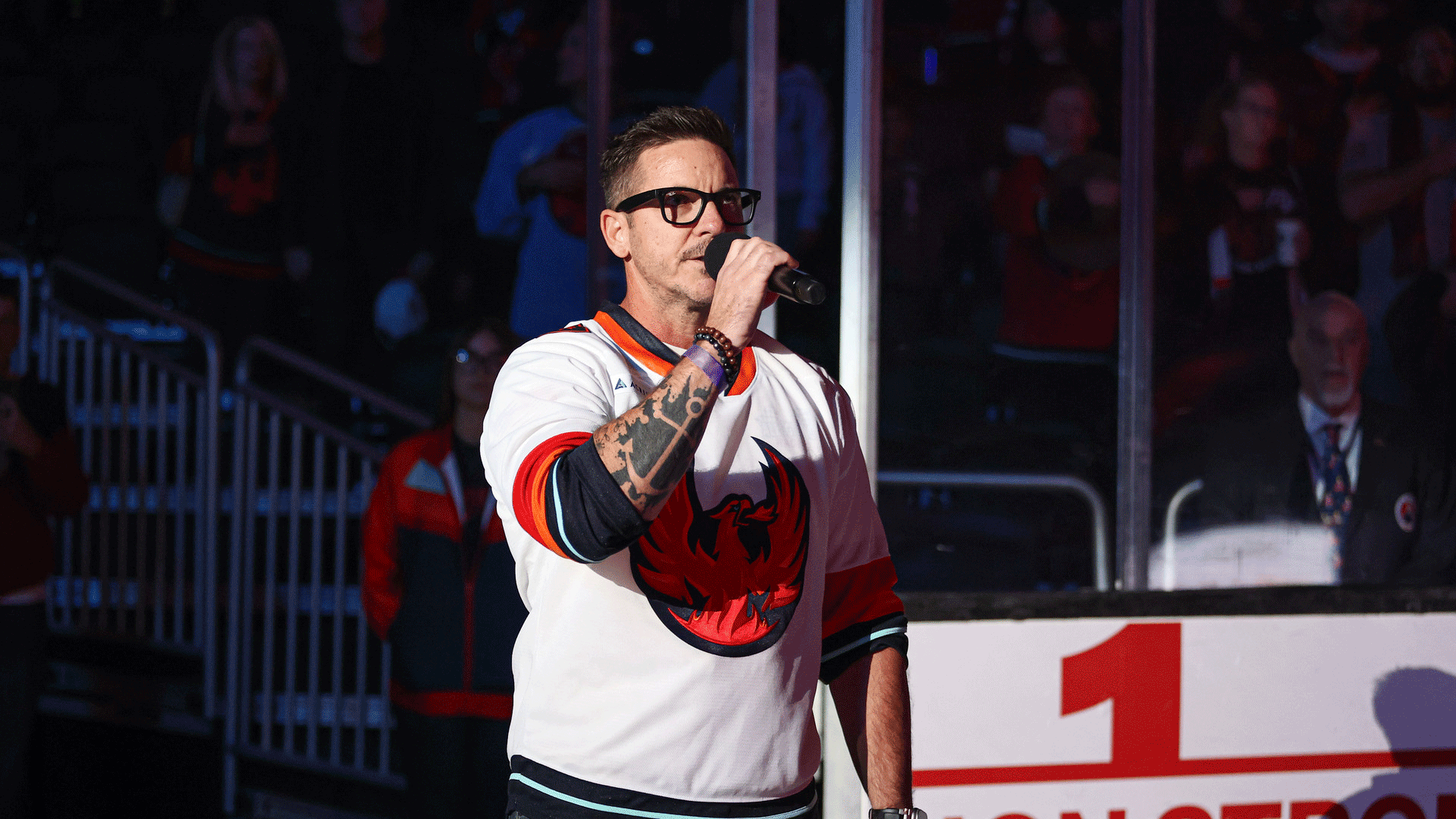 Singer performing the national anthem on the ice at a Coachella Valley Firebirds game